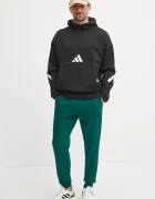 adidas Спортен панталон Essentials в зелено с десен JD1860