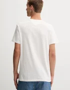 Tommy Jeans Памучна тениска в бежово с десен DM0DM21977