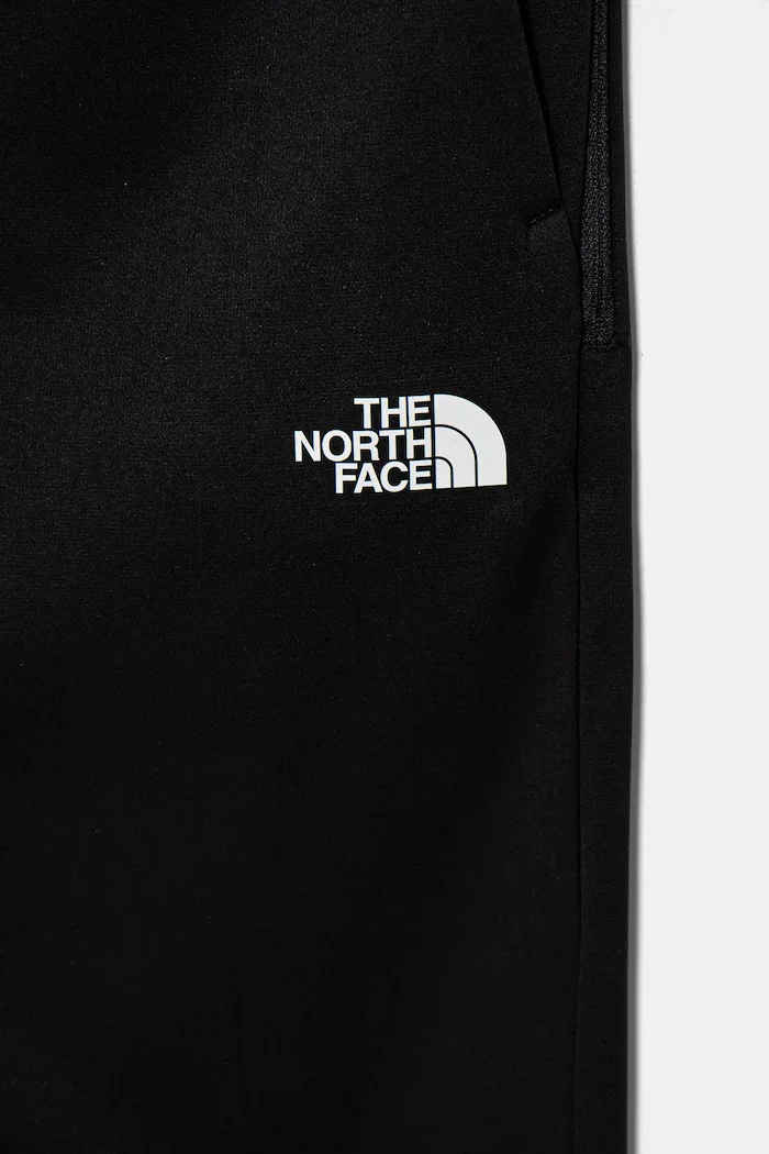 The North Face Детски спортен панталон MOUNTAIN ATHLETICS JOGGERS в черно с принт NF0A89HWKY41