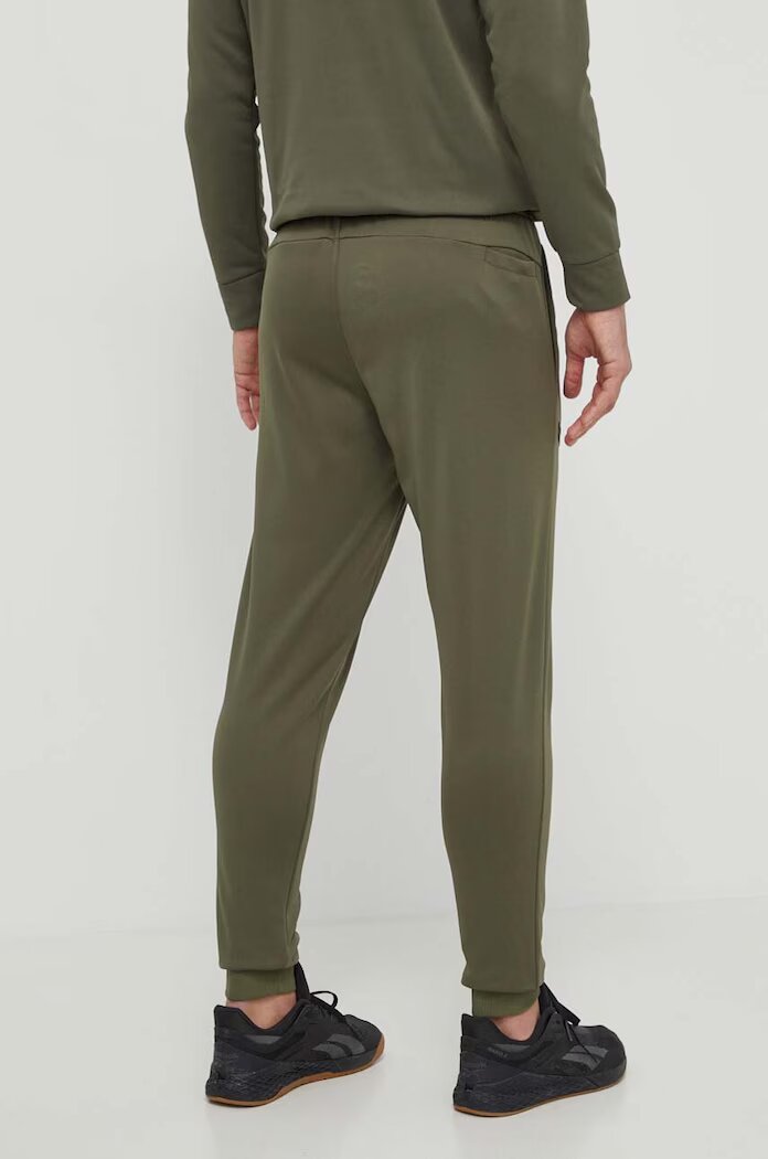 Under Armour Спортен панталон Fleece в зелено с изчистен дизайн