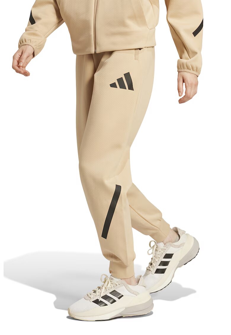 adidas Sportswear Спортен панталон Z.N.E. с джобове с цип - Черен/Бежов